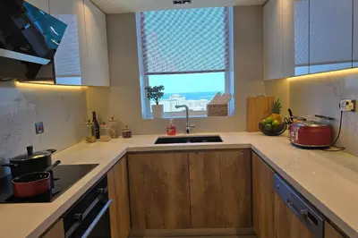 a kitchen with a sink and a window at Beachfront 250 view private beach high floor in Dubai