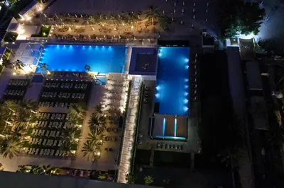 an overhead view of a swimming pool at night at Beachfront 250 view private beach high floor in Dubai
