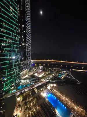 a view of a city at night with buildings at Beachfront 250 view private beach high floor in Dubai