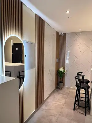 a kitchen with a counter and stools in a room at Capsule Hostel Room in Business Bay Near Downtown in Dubai