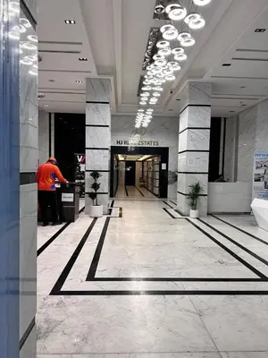 a man standing in a lobby of a building at Capsule Hostel Room in Business Bay Near Downtown in Dubai