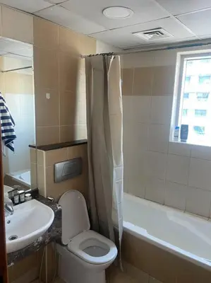 a bathroom with a sink and a toilet and a tub at Marina, Beach & Mall Walking Dis in Dubai
