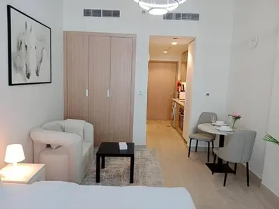 a living room with a couch and a table at Stonetree - Studio Unit at Azizi Riviera 45 in Dubai