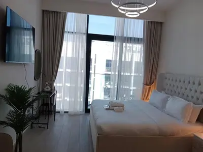 a bedroom with a large bed and a large window at Stonetree - Studio Unit at Azizi Riviera 45 in Dubai