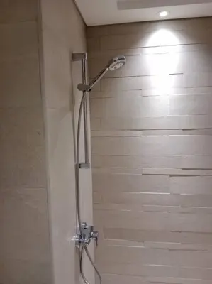 a shower with a shower head in a bathroom at Stonetree - Studio Unit at Azizi Riviera 45 in Dubai