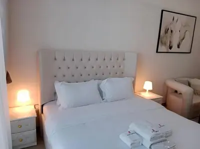 a bedroom with a white bed with two towels on it at Stonetree - Studio Unit at Azizi Riviera 45 in Dubai