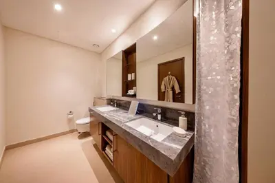 a bathroom with a sink and a shower at Large 2BR with Marina and Sea View in 5242 Tower - EE Holiday Homes in Dubai