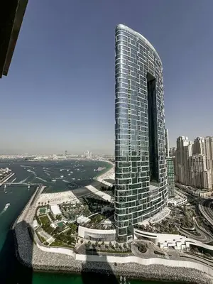 an aerial view of a tall building near the water at Large 2BR with Marina and Sea View in 5242 Tower - EE Holiday Homes in Dubai