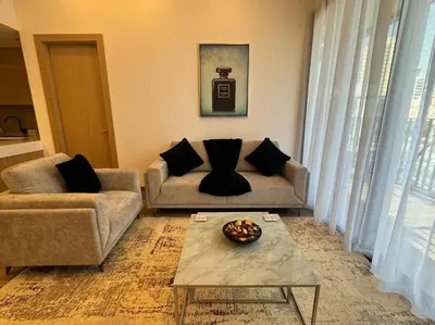 a living room with a couch and a coffee table at Luxury Apartment in Oakley Square Residences, JVC in Dubai
