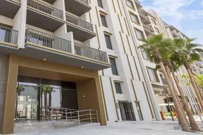 a building with palm trees in front of it at Sukoon's Elegant Suite 2 in Dubai