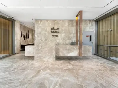 a lobby with a stone wall and a marble floor at Sukoon's Elegant Suite 2 in Dubai