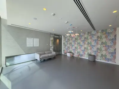 a large lobby with a couch and a tile wall at 2BR near Dubai Mall, Burj views! in Dubai