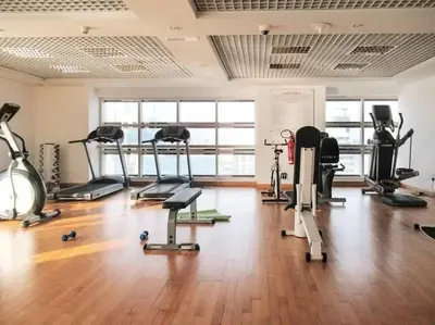 a gym with several treadmills and exercise bikes at JLT Studio apartment Goldcrest Executive in Dubai