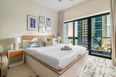 a bedroom with a large bed and a large window at GuestReady - Stunning studio in JLT in Dubai