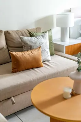 a couch with pillows and a table in a living room at GuestReady - Stunning studio in JLT in Dubai