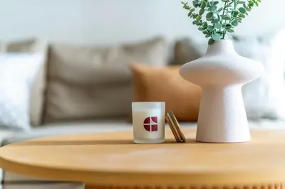 a coffee table with a coffee cup and a vase at GuestReady - Stunning studio in JLT in Dubai