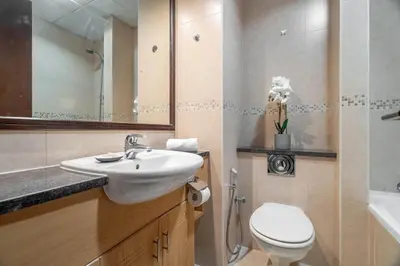 a bathroom with a sink and a toilet and a tub at GuestReady - Stunning studio in JLT in Dubai