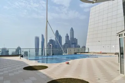 a swimming pool on top of a building with a city skyline at GuestReady - Stunning studio in JLT in Dubai