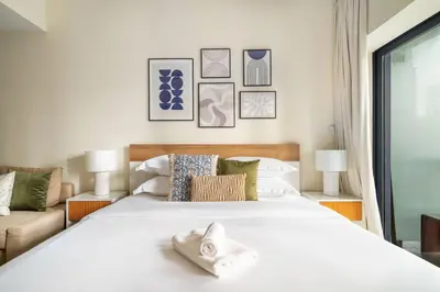 a bedroom with a large white bed with pillows at GuestReady - Stunning studio in JLT in Dubai