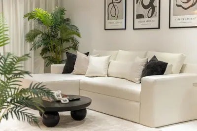 a living room with a white couch and a table at StayShort - Luxurious 2-Bedroom Apartment perfect for families in Dubai Marina in Dubai