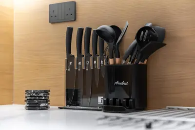 a black container filled with utensils on a counter at StayShort - Luxurious 2-Bedroom Apartment perfect for families in Dubai Marina in Dubai