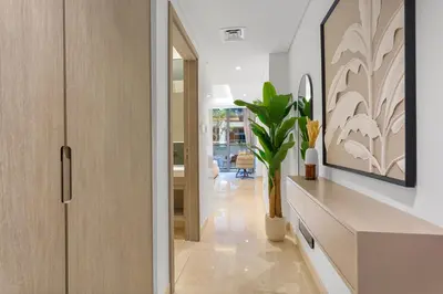 a hallway with a table and a vase with a plant at Luxury Living Studio in the Heart of Business Bay in Dubai