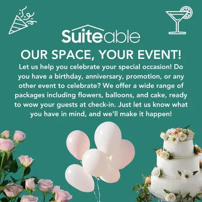 a white wedding cake with pink flowers on a blue background at Luxury Living Studio in the Heart of Business Bay in Dubai