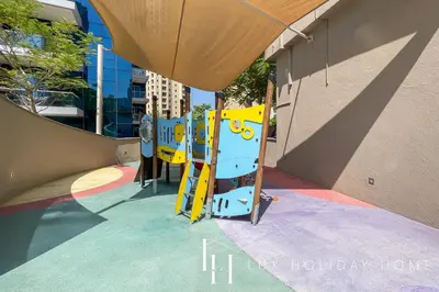 a playground with a slide in a building at LUX The Shemara Marina View Suite in Dubai