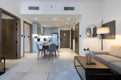 a living room with a couch and a table at Livbnb-Classy 2B with Jacuzzi & BurjKhalifa View in Dubai