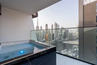 a swimming pool on a building with a view of a city at Livbnb-Classy 2B with Jacuzzi & BurjKhalifa View in Dubai