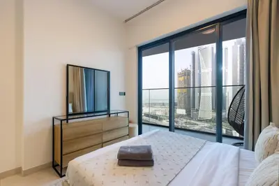 a bedroom with a bed and a large window at Livbnb-Classy 2B with Jacuzzi & BurjKhalifa View in Dubai