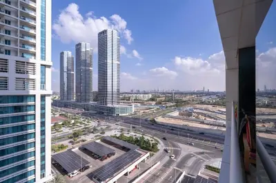 an aerial view of a city with tall buildings at Waves - Cozy Studio with Balcony & Partial Lake Views in Dubai