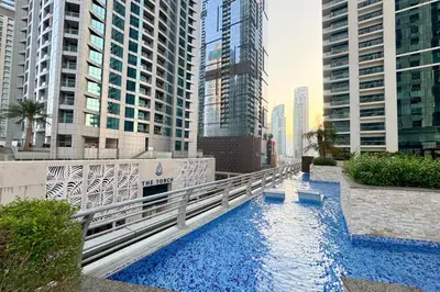 a bridge over a river in a city with tall buildings at Dubai Marina FLOOR 89 - AMAZING VIEWS in Dubai