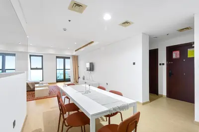 a kitchen and dining room with a white table and chairs at Dubai Marina FLOOR 89 - AMAZING VIEWS in Dubai