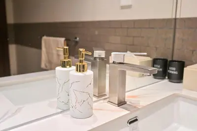 a bathroom with two bottles ofodorizers on a sink at Luxury 1 Bed with full Marina View - Emaar Park Island in Dubai