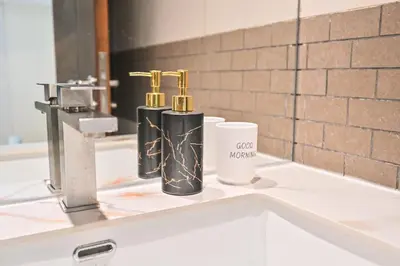 two black and gold bottles on a bathroom sink at Luxury 1 Bed with full Marina View - Emaar Park Island in Dubai