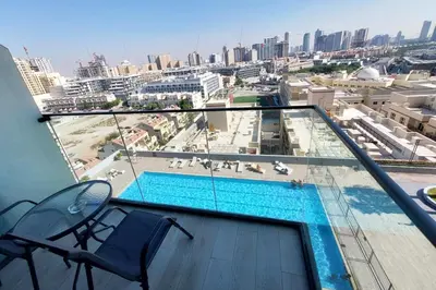 a balcony with a swimming pool on top of a building at Bloom Tower C - JVC by Golden Casa in Dubai