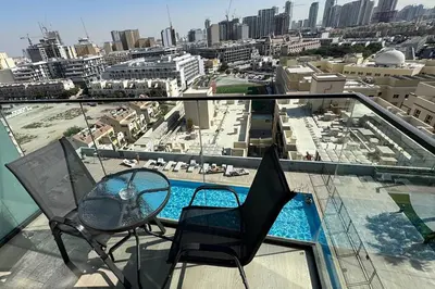 a balcony with chairs and a view of a city at Bloom Tower C - JVC by Golden Casa in Dubai