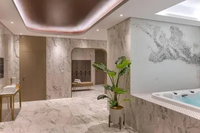 a bathroom with a tub and a potted plant at Highest Infinity Pool Burj Khalifa View in Dubai