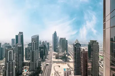 an aerial view of a city with tall buildings at Highest Infinity Pool Burj Khalifa View in Dubai