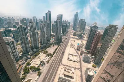 an aerial view of a city with tall buildings at Highest Infinity Pool Burj Khalifa View in Dubai