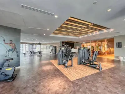 a gym with cardio equipment in a large room at Highest Infinity Pool Burj Khalifa View in Dubai