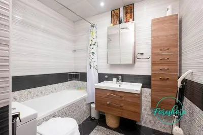 a bathroom with a tub and a sink and a toilet at Blissful One Bedroom Apartment in Dubai