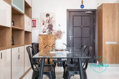 a dining room table with black chairs in a kitchen at Blissful One Bedroom Apartment in Dubai