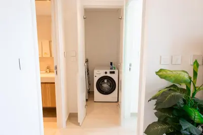 a laundry room with a washer and dryer at INA HOMES - 1BHK Downtown Views Direct Access to Dubai Mall in Dubai