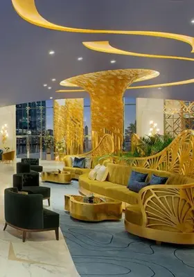 a lobby with couches and chairs in a building at Spacious Studio with Pool - Canal & Burj Views in Dubai