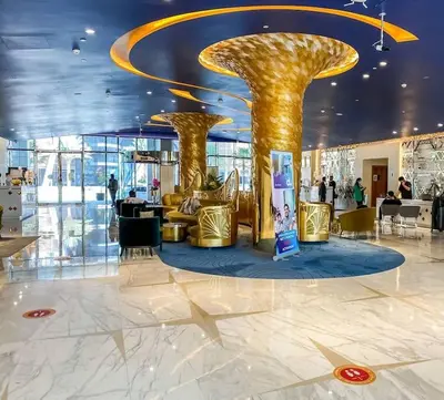 a lobby with two gold columns in a building at Spacious Studio with Pool - Canal & Burj Views in Dubai