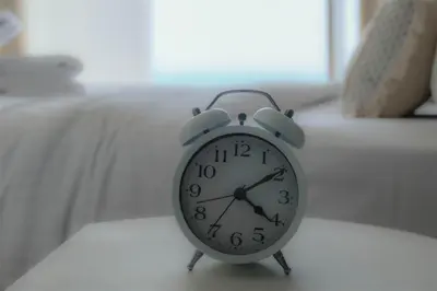 a clock sitting on top of a table at Mira Holiday Homes - Luxury 1 bedroom with sea view in Dubai