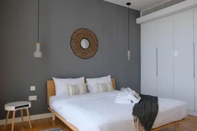 a bedroom with a bed with a mirror on the wall at Mira Holiday Homes - Luxury 1 bedroom with sea view in Dubai