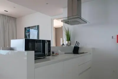 a kitchen with a microwave and a tv on a counter at Mira Holiday Homes - Luxury 1 bedroom with sea view in Dubai